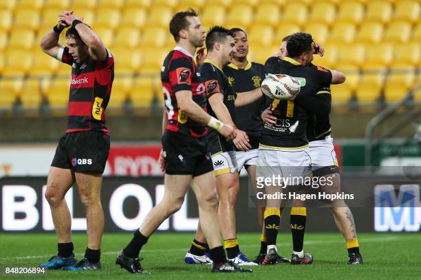 Regan Verney of Wellington celebrates his try with teammates Jackson Garden-Bachop, Malo Tuitama and Sheridan Rangihuna during the round five Mitre...