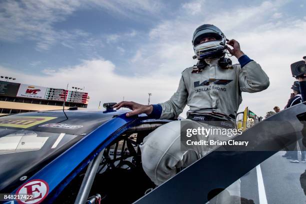 Michael Cooper climbs from his car after winning the GoPro Grand Prix of Sonoma Pirelli World Challenge GT race at Sonoma Raceway on September 16,...