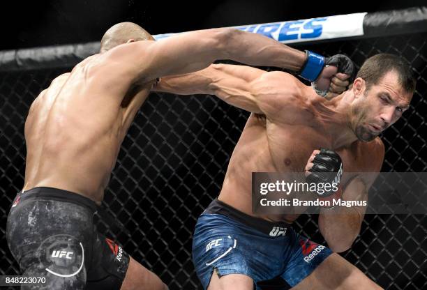 Luke Rockhold exchanges punches with David Branch in their middleweight bout during the UFC Fight Night event inside the PPG Paints Arena on...
