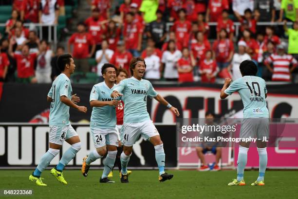Shohei Takahashi of Jubilo Iwata celebrates the opening goal with his team mates during the J.League J1 match between Jubilo Iwata and Urawa Red...