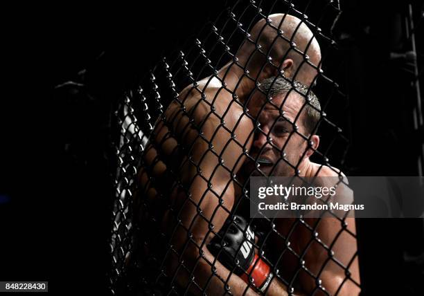 Luke Rockhold pushes David Branch up against the cage in their middleweight bout during the UFC Fight Night event inside the PPG Paints Arena on...