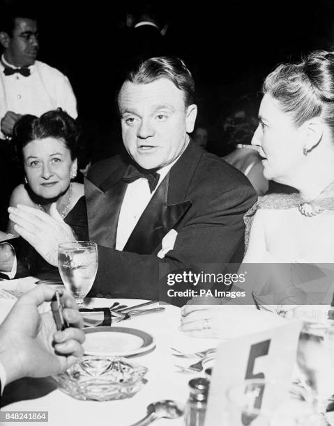 Veteran American film tough-guy James Cagney at a Hollywood party. At left is his wife Frances Vernon, and at right is Eloise O'Brien, wife of film...