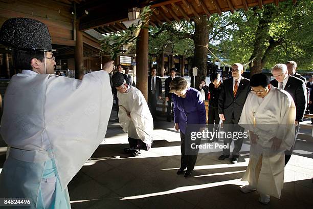 Secretary of State Hillary Clinton bows as she attends a purification ceremony during her visit to the Meiji Shrine on February 17, 2009 in Tokyo,...