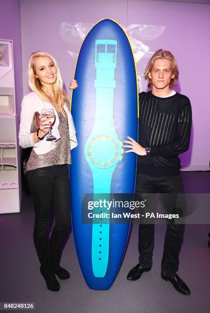 Richard Dinan and unnamed guest arrive at the Swatch Chrono Plastic launch party at the Future Gallery in London.