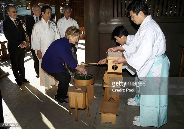 Secretary of State Hillary Clinton washes her hands before entering the Meiji Shrine on February 17, 2009 in Tokyo, Japan. Clinton is on her first...