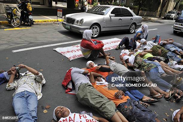 Some 100 landless Filipino farmers rally outside the offices of Jose Miguel Arroyo, the husband of President Gloria Arroyo, in Manila's financial...