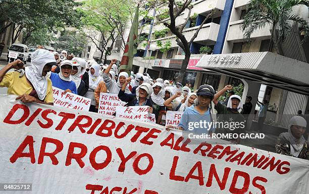 Some 100 landless Filipino farmers rally outside the offices of Jose Miguel Arroyo, the husband of President Gloria Arroyo, in Manila's financial...