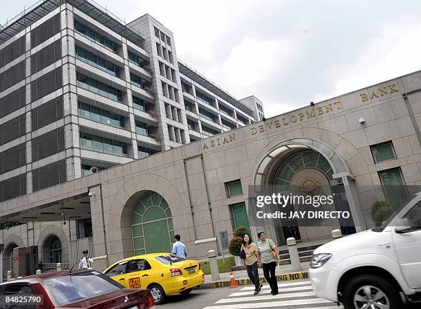 Cars drive past the Manila headquarters of the Asian Development Bank on February 17, 2009. The bank said it sanctioned 41 companies and 38...