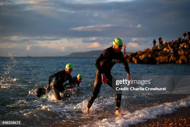 Participants exit the water as they finish the swim leg of the race during IRONMAN 70.3 Weymouth on September 17, 2017 in Weymouth, England.