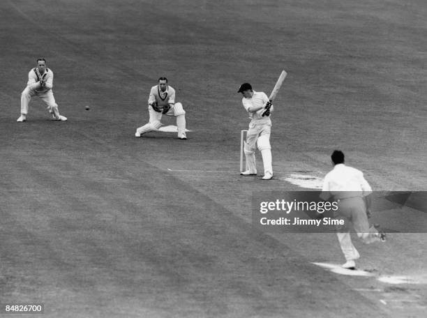 Essex opening batsman Dickie Dodds , hitting out at a ball from Alec Bedser during a match against Surrey at The Oval, London, 20th May 1950.