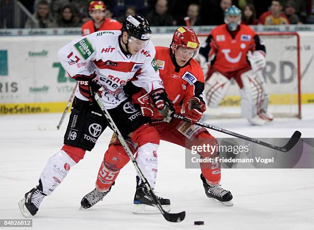 Christoph Ullmann of Hannover and Patrick Koeppchen of Koelner Haie compete for the puck during the DEL Bundesliga game between Hannover Scorpions...