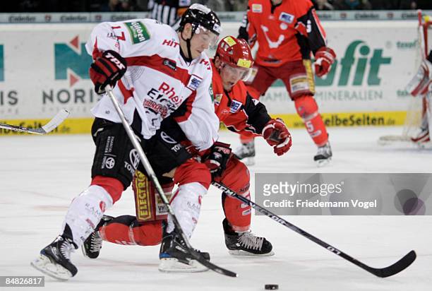 Christoph Ullmann of Hannover and Patrick Koeppchen of Koelner Haie compete for the puck during the DEL Bundesliga game between Hannover Scorpions...