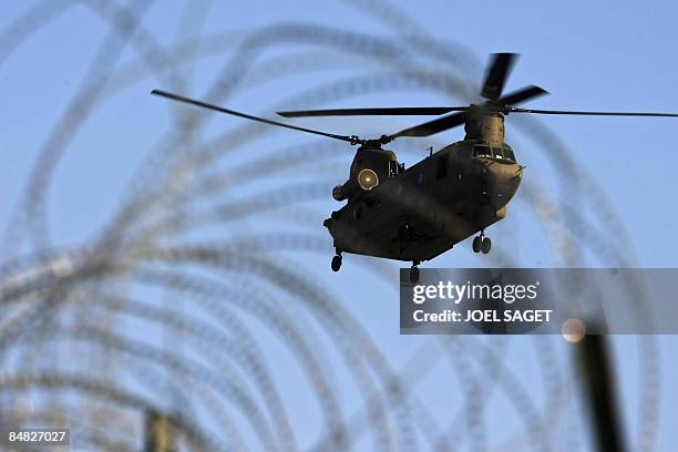 Chinook helicopter flies over barbed wire at FOB Morales-Frazier in Nijrab on February 17, 2009. The deterioration in security in Afghanistan has...
