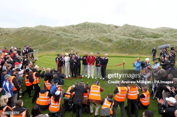 Donald Trump cuts the ribbon as he officially opens the Trump International Golf Links golf course near Aberdeen.