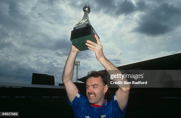 Scottish footballer John Wark of Ipswich Town raises the Division 2 championship trophy after a match against Brighton, 2nd May 1992. Ipswich won 3-1.