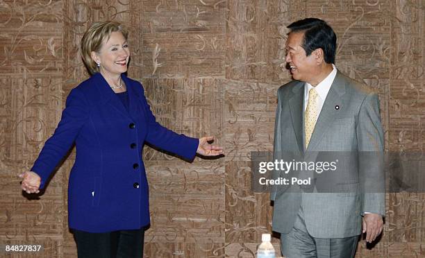 Secretary of State Hillary Clinton speaks to Japan's main opposition Democratic Party of Japan leader Ichiro Ozawa prior to their meeting at a Tokyo...