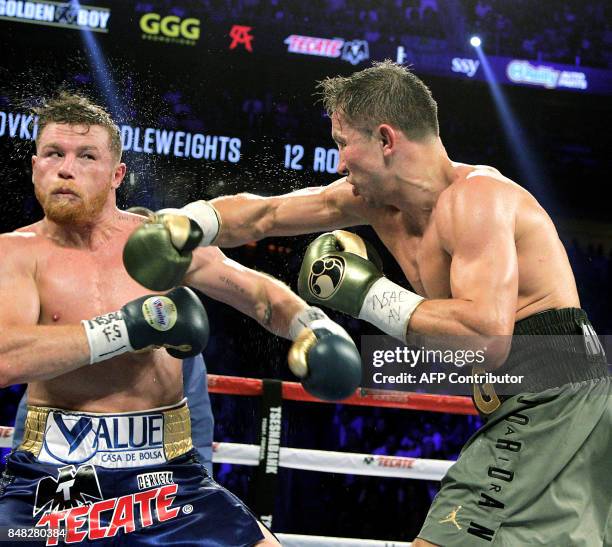 Canelo Alvarez reacts against a right hook from Gennady Golovkin during their WBC, WBA and IBF middleweight championship fight at the T-Mobile Arena...