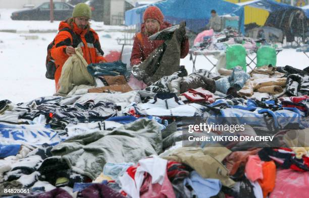People browse clothes at an open-air second-hand clothing and goods market outside Minsk in Zhdanovichi on February 17, 2009. The average monthly...