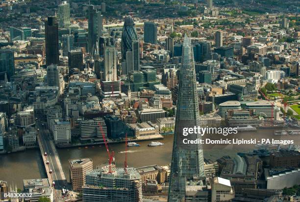 Aerial view of central London, showing the Shard , and the City financial district, including the Swiss Re Tower, also known as the Gherkin .