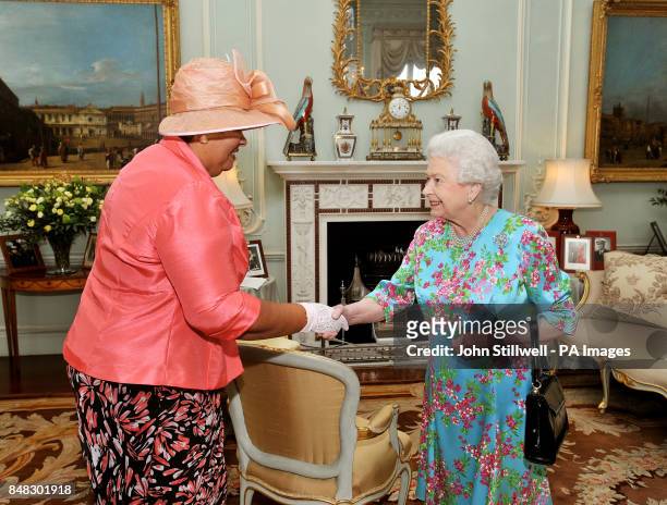 Queen Elizabeth II talks with Mrs Aloun Ndombet-Assamba the High Commissioner for Jamaica, during a private audience at Buckingham Palace in central...