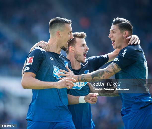 Sandro Wagner of Hoffenheim celebrates his team's first goal with team mates Havard Nordtveit and Steven Zuber during the Bundesliga match between...