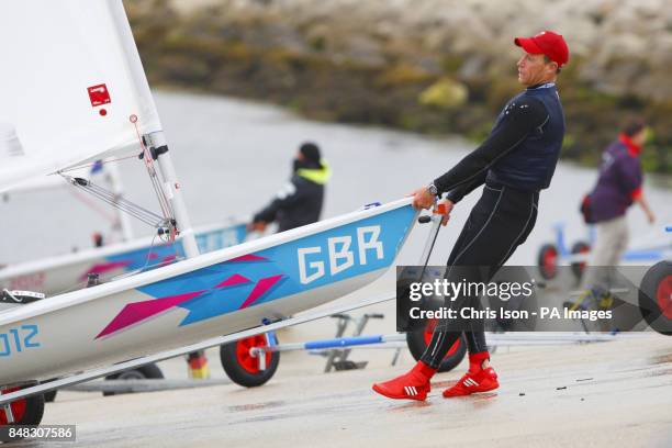 British Laser sailor Paul Goodison pulls his boat from the water at the Weymouth and Portland Sailing Academy, Weymouth.