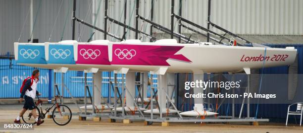 The British Olympic team Manager Stephen Park walks past freshly branded Eliott 6m keel-boats at the Weymouth and Portland Sailing Academy, Weymouth.
