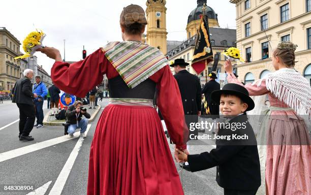 Performers in traditional Bavarian costumes march over Munich's famous Ludwigstrasse during the traditional Costume and Riflemen's Procession at day...