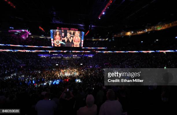 General view shows singer Courtney Laine Mazza performing the American national anthem prior to the WBC, WBA and IBF middleweight championship bout...