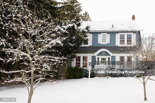 house with snow in winter - winter house stock pictures, royalty-free photos & images