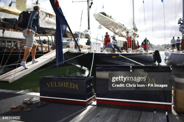 The crew of Velsheda leave their shoes on the pontoon before boarding as they prepare to sail on the second day of the J-Class Solent Regatta off...