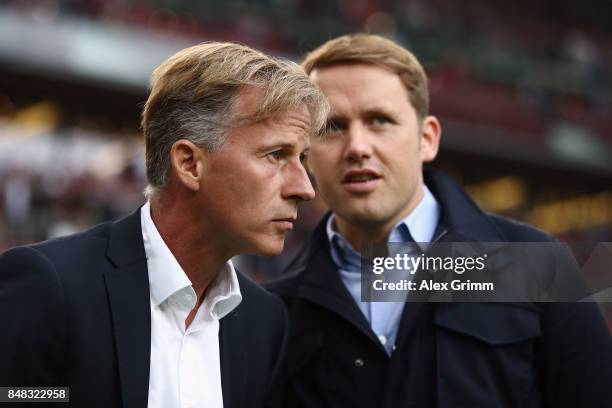 Head coach Andries Jonker and sport director Olaf Rebbe look on prior to the Bundesliga match between VfB Stuttgart and VfL Wolfsburg at...