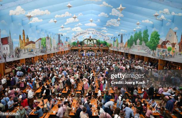 Visitors celebrate in the beer tent 'Hacker-Pschorr - Himmel der Bayern' at day 2 of the 2017 Oktoberfest beer festival on September 17, 2017 in...