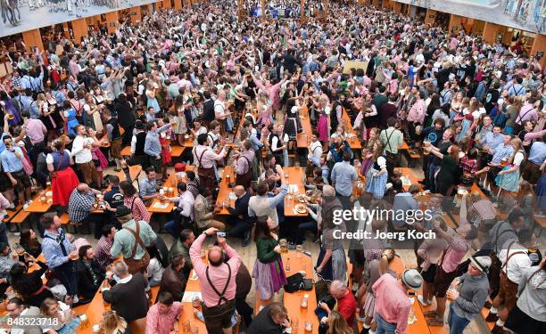 Visitors celebrate in the beer tent 'Hacker-Pschorr - Himmel der Bayern' at day 2 of the 2017 Oktoberfest beer festival on September 17, 2017 in...