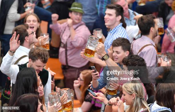 Visitors celebrate in the beer tent 'Hacker-Pschorr - Himmel der Bayern' at day 2 of the 2017 Oktoberfest beer festival on September 17, 2017 in...