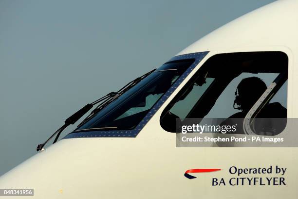 British Airways pilot parks an aircraft at London's City Airport, London.