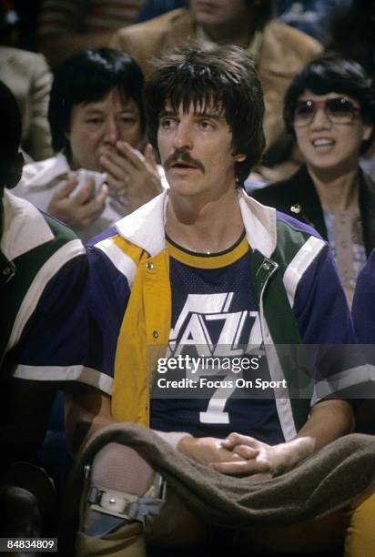 S: Pete Maravich of the New Orleans Jazz watches the action from the bench against the Washington Bullets during a late circa 1970's NBA basketball...