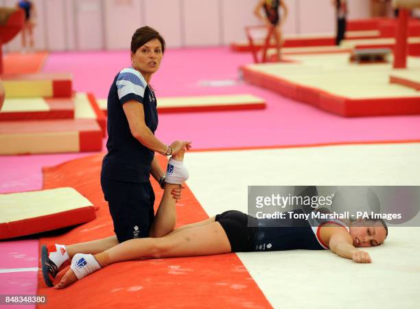 Great Britain's Beth Tweddle receives treatment from coach Amanda Reddin during the training session at Greenwich Academy, London.