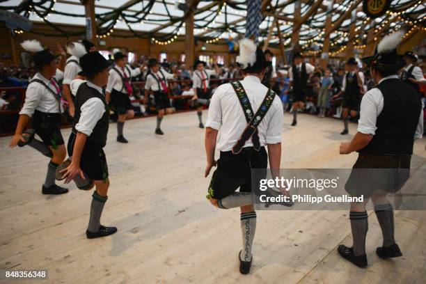 Boys in traditional bavarian Lederhosen perform a "Schuhplattler" dance in the "Tradition" tent on the second day of the 2017 Oktoberfest beer fest...