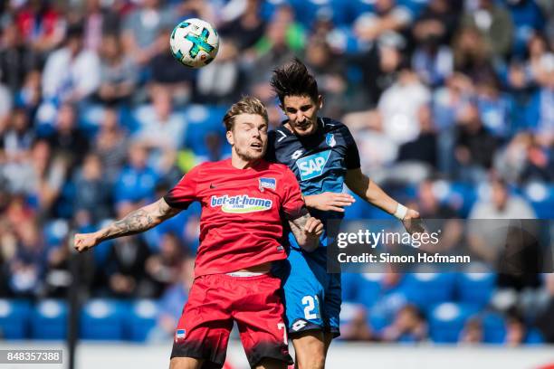 Alexander Esswein of Berlin jumps for a header Benjamin Huebner of Hoffenheim during the Bundesliga match between TSG 1899 Hoffenheim and Hertha BSC...