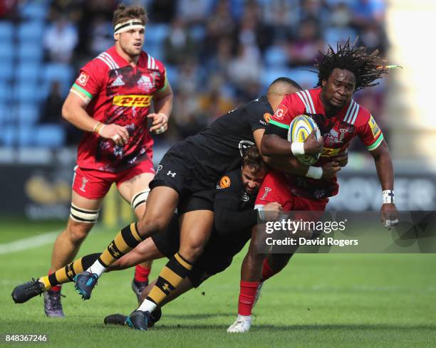 Marland Yarde of Harlequins is tackled by Marcus Watson and Danny Cipriani during the Aviva Premiership match between Wasps and Harlequins at The...