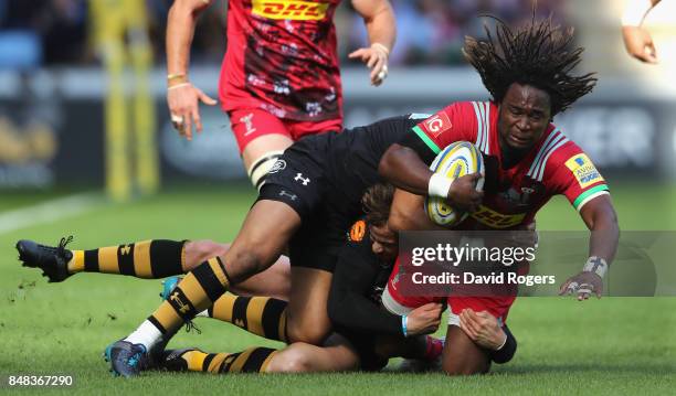 Marland Yarde of Harlequins is tackled by Marcus Watson and Danny Cipriani during the Aviva Premiership match between Wasps and Harlequins at The...