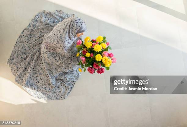 muslim woman at home with flowers - muslim wedding stock pictures, royalty-free photos & images