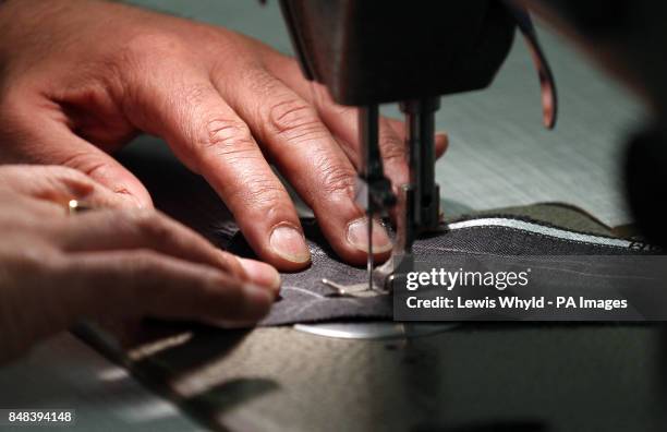 Scenes Tailors at work in the London Savile Row tailors, Gieves & Hawkes.