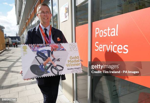 Veteran postman of 17 years, Doug Mowatt, from Temple Heath, delivers a giant Royal Mail stamp commemorating Great Britain's Gold Medal winner to the...