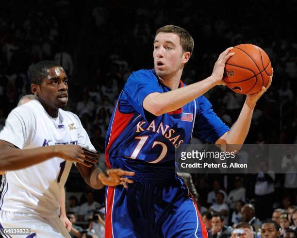 Brady Morningstar of the Kansas Jayhawks looks to make a pass against pressure from Fred Brown of the Kansas State Wildcats on February 14, 2009 at...