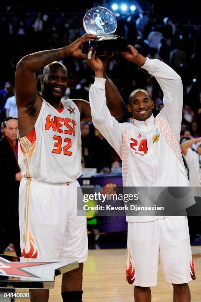 Co-MVPs Shaquille O'Neal and Kobe Bryant of the Western Conference hold up the trophy after the Western Conference defeated the Eastern Conference in...