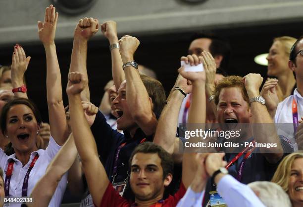 Prince Harry cheers on Great Britain in the Men's Team Sprint as he sits with the Duke and Duchess of Cambridge during day six of the Olympic Games...