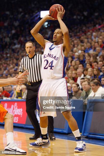 Travis Releford of the Kansas Jayhawks looks to pass the ball against the Oklahoma State Cowboys during the game at Allen Fieldhouse on February 7,...