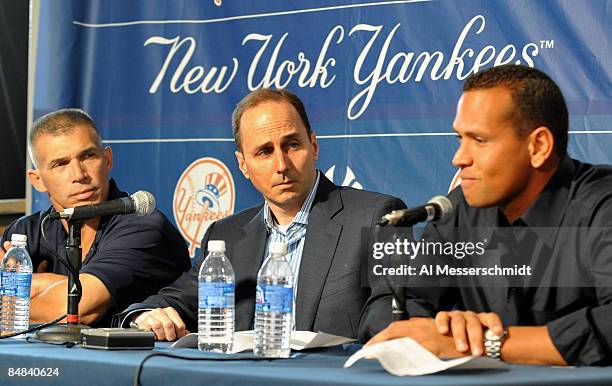 Infielder Alex Rodriguez of the New York Yankees talks during a press conference as Manager Joe Girardi and General Manager Brian Cashman listen...